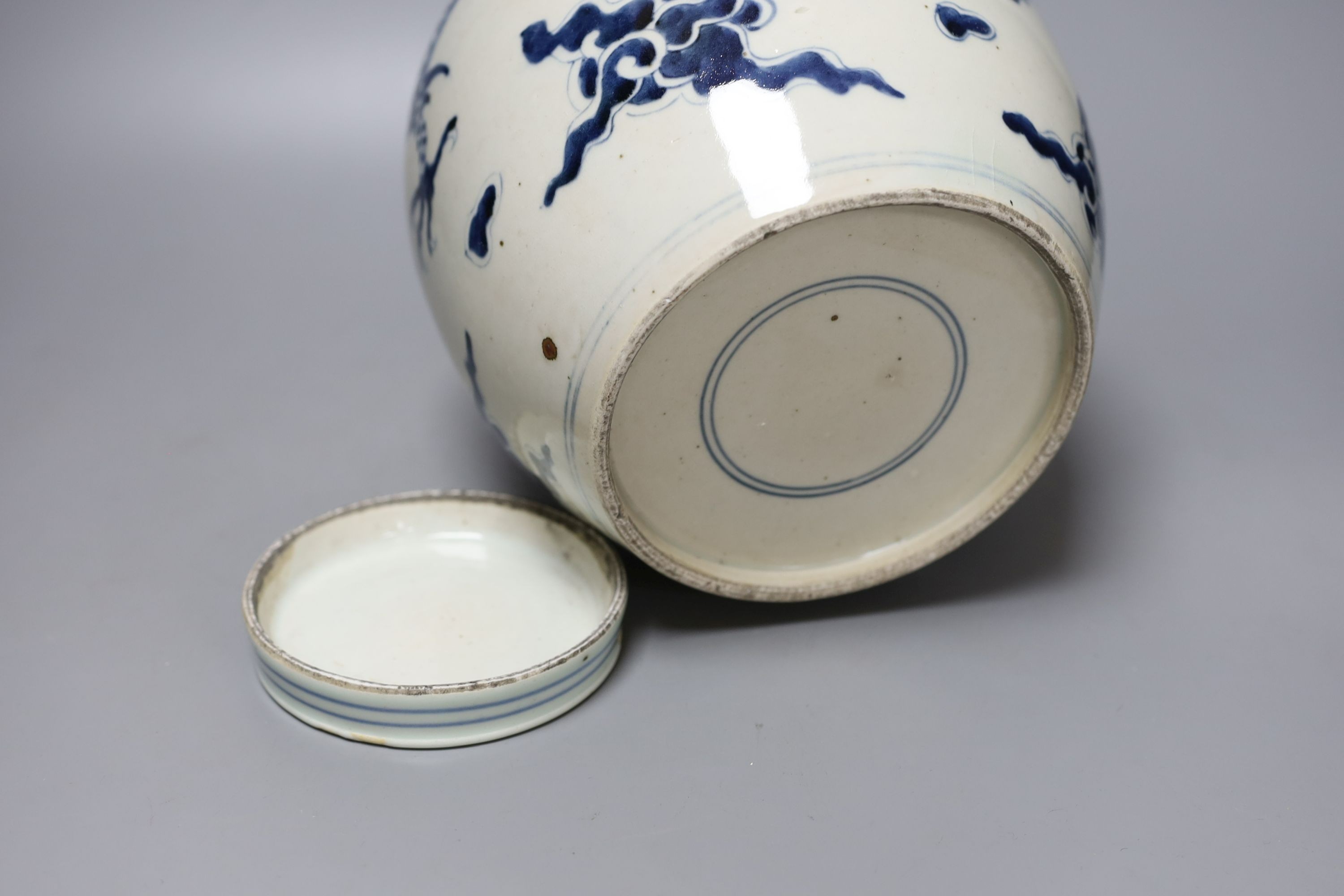 A Chinese blue and white ‘dragon’ jar and associated cover, collectors mark to shoulder. 22cm